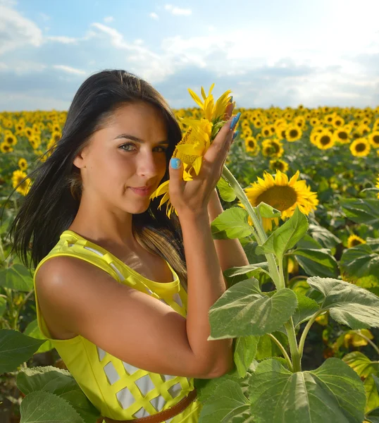 Woman in sunflower field - rural life and aromatherapy concept