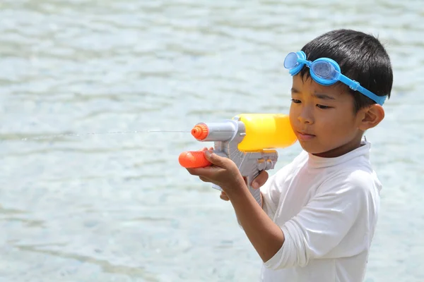 Japanese boy playing with water gun (first grade at elementary school)