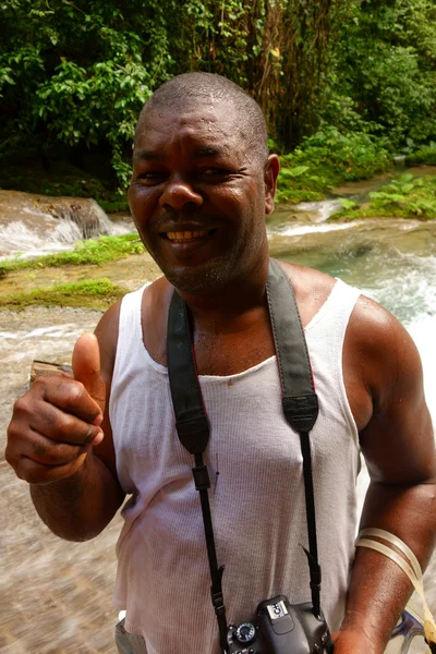 Male tourist guide at Reach Falls and lush rain forest in Portland parish, Jamaica