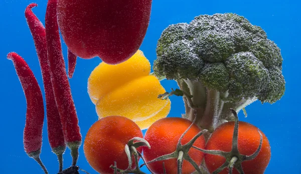 Splashing fruit on water. Fresh Fruit and Vegetables being  shot as they submerged under water.