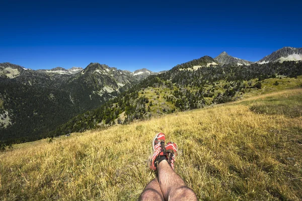 Landscape and legs during mountain hiking at Pyrenean mountain