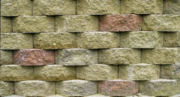 Multi-colored blocks on a retaining wall.