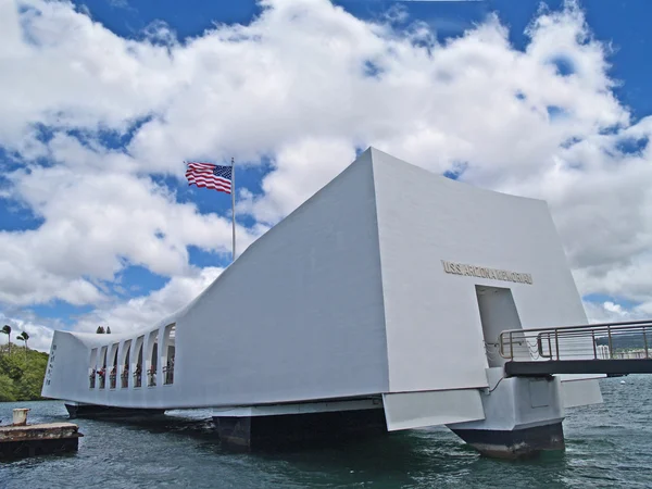 US Flag flying above the USS Arizona Memorial in Pearl Harbor, Honolulu, Hawaii.