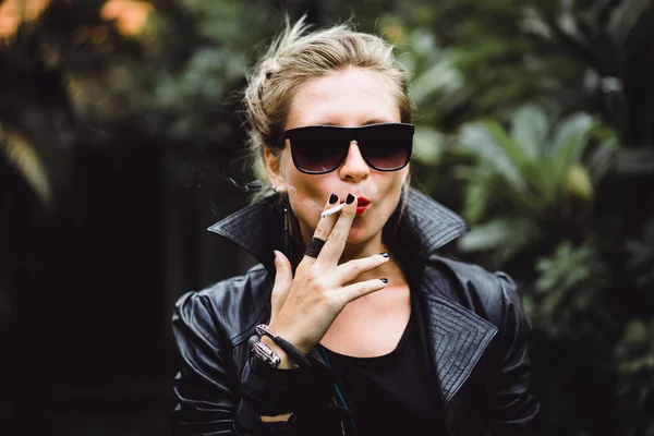 Beautiful woman smokes a cigarette.