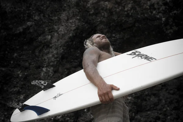 Brutal man surfer with long white hair