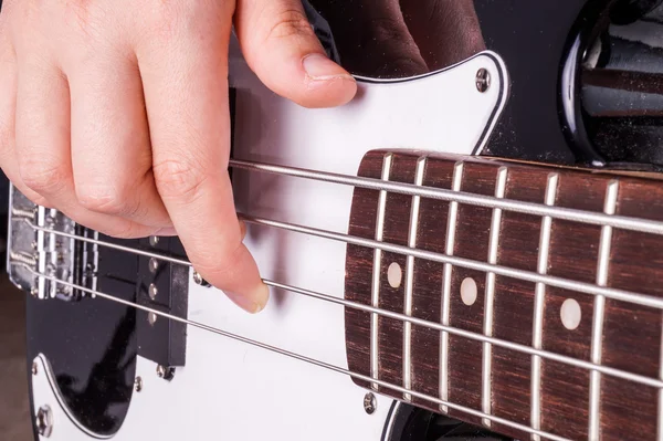 Hands of an teenager plays guitar