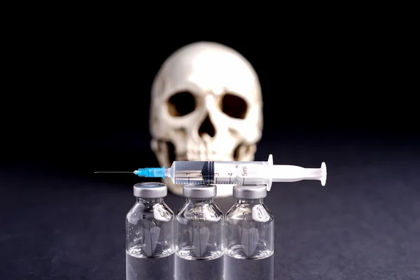 Skull, syringe and medical vials