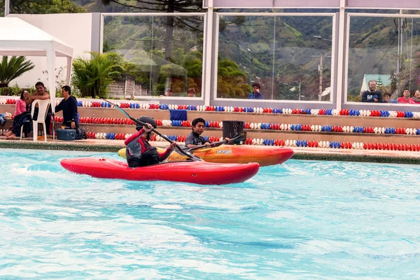 Team Competes At The Canoeing Contest In A Swimming Pool
