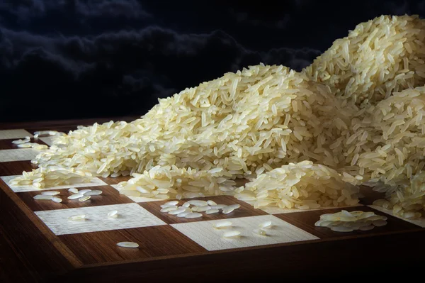 Chessboard with growing heaps of rice grains, concept of exponential growth