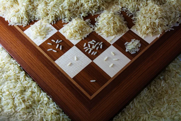 Chessboard with growing heaps of rice grains, view from above showing the exponential function and unlimited growth