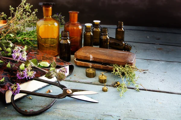 Preparing natural medicine, healing herbs, scissors and apotheca