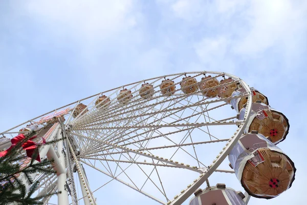Ferris wheel on a funfair against blue sky