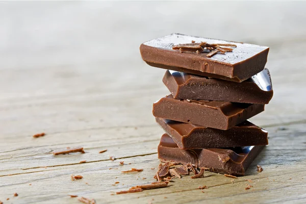 Stack of chocolate pieces, close up shot with selected focus