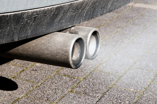 Dirty dual exhaust pipes of a car