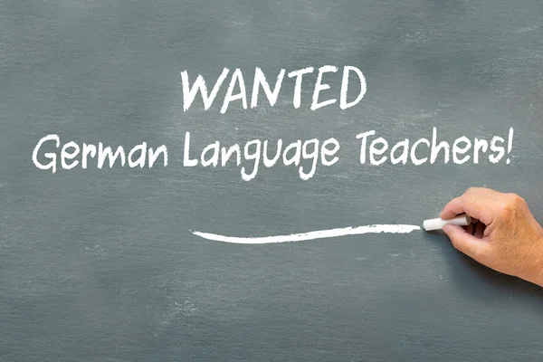 Hand writing on a chalkboard Wanted German language teachers