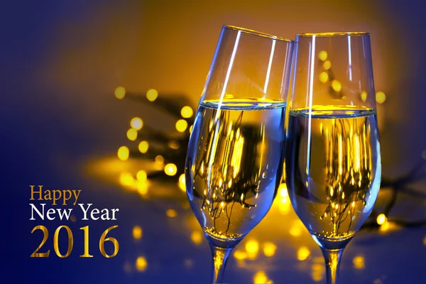 Two champagne flutes against blue yellow background, text Happy
