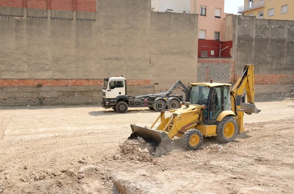 Yellow excavator in the street