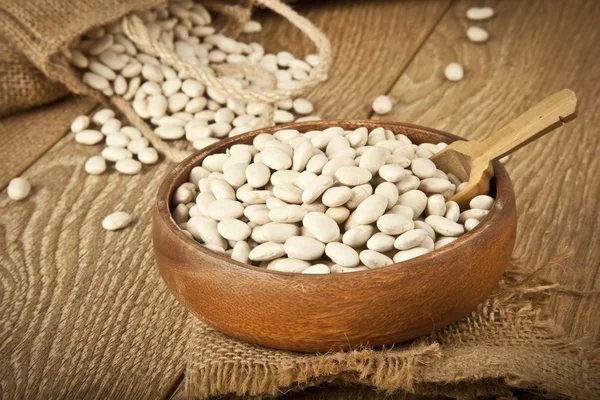 White beans in a wooden bowl with traditional turkish concept background