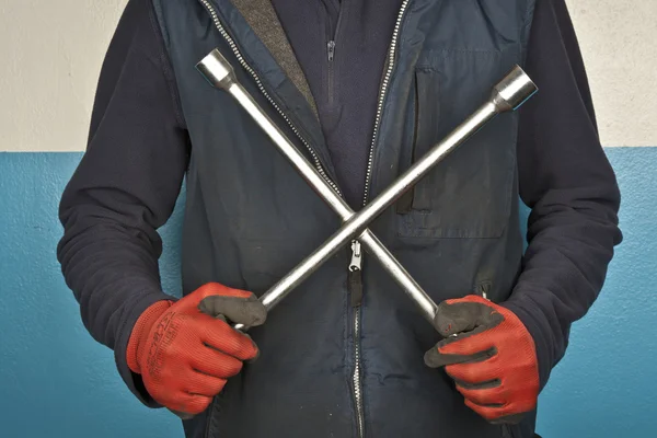 Wheel wrench in hand with gloves