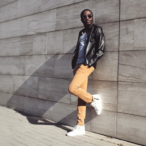 Street fashion, stylish young african man wearing a sunglasses a
