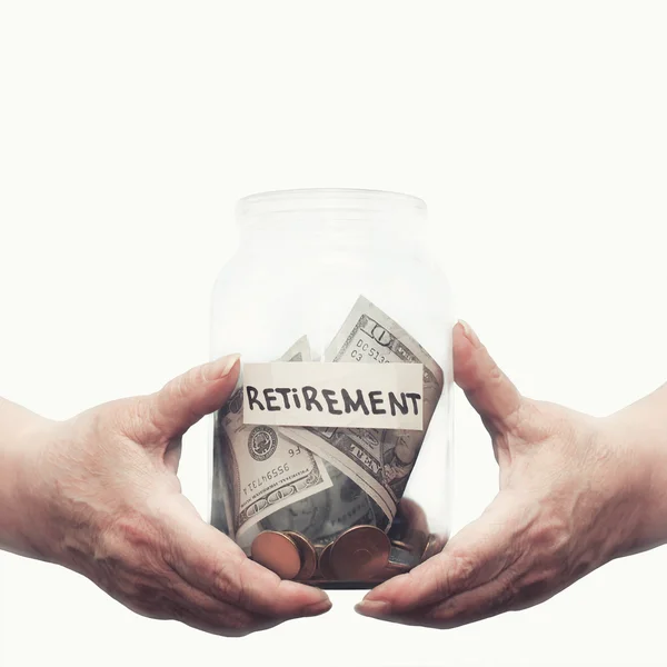 Elderly hands holding glass jar with money on a pension closeup