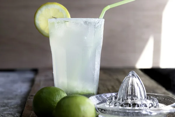A glass of homemade lemonade with limes and lime juice
