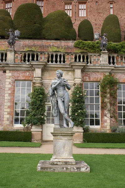 Statue of a musician playing flute,  Powis Castle, Wales, England