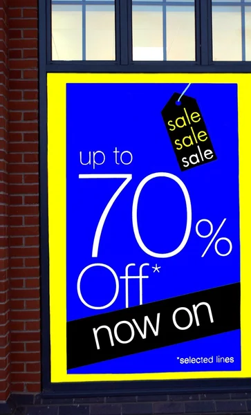 Sale sign. up to seventy percent off sale sign. store\'s window blue sale sign.