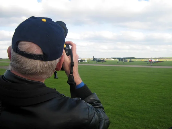 Photographer taking photo of aircrafts in an airfield