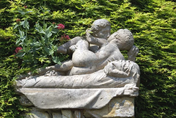 Statues of a couple kissing, The Italian garden of Hever Castle, Kent, England