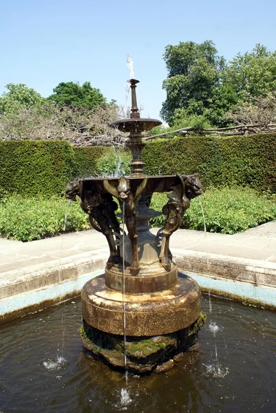 Copper-gargoyle-water-fountain in a garden, Hever castle, Kent, England