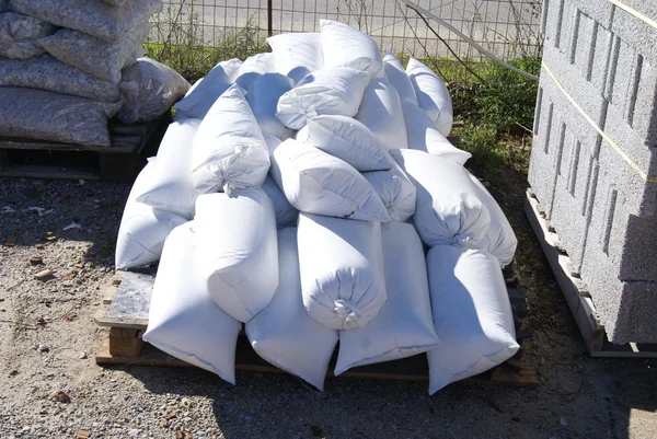 Construction sand bags, stone chips, and bricks