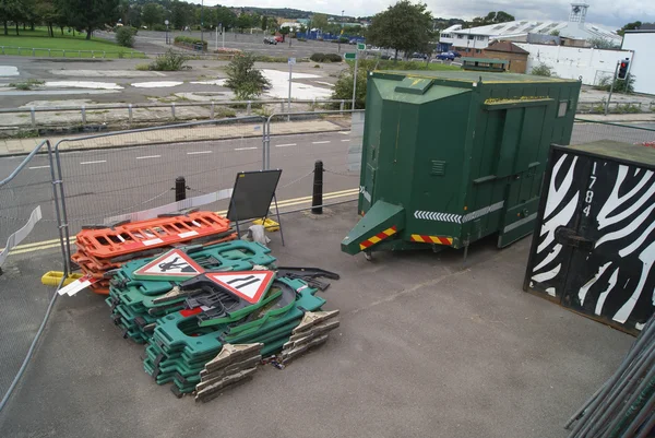 Cargo containers, traffic road signs, and road railings in a street. road work site. construction site