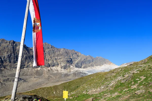 Mountain panorama with Austrian flag in Hohe Tauern Alps, Austria