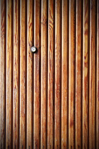 Door lens peephole on wooden texture