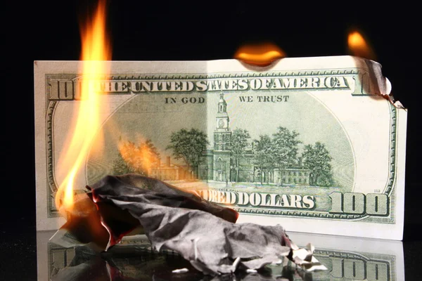 Dollars in fire, burning dollar, ashes. Crisis