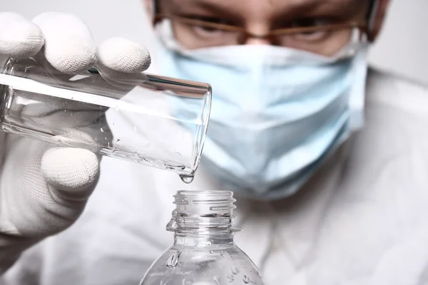 Scientist pouring water. Liquid, flask, lab.