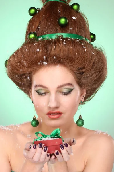 Christmas Woman. Beautiful New Year and Christmas Tree Holiday Hairstyle and Make up. Beauty Girl Portrait.