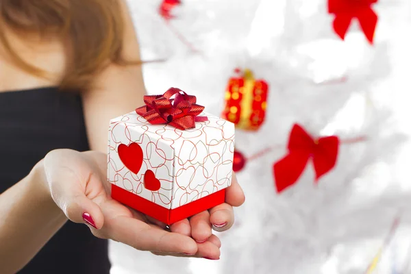 Hands holding beautiful gift box, female giving gift, Christmas holidays