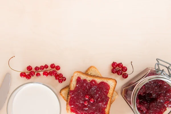 Bread with jam for breakfast, milk and background space