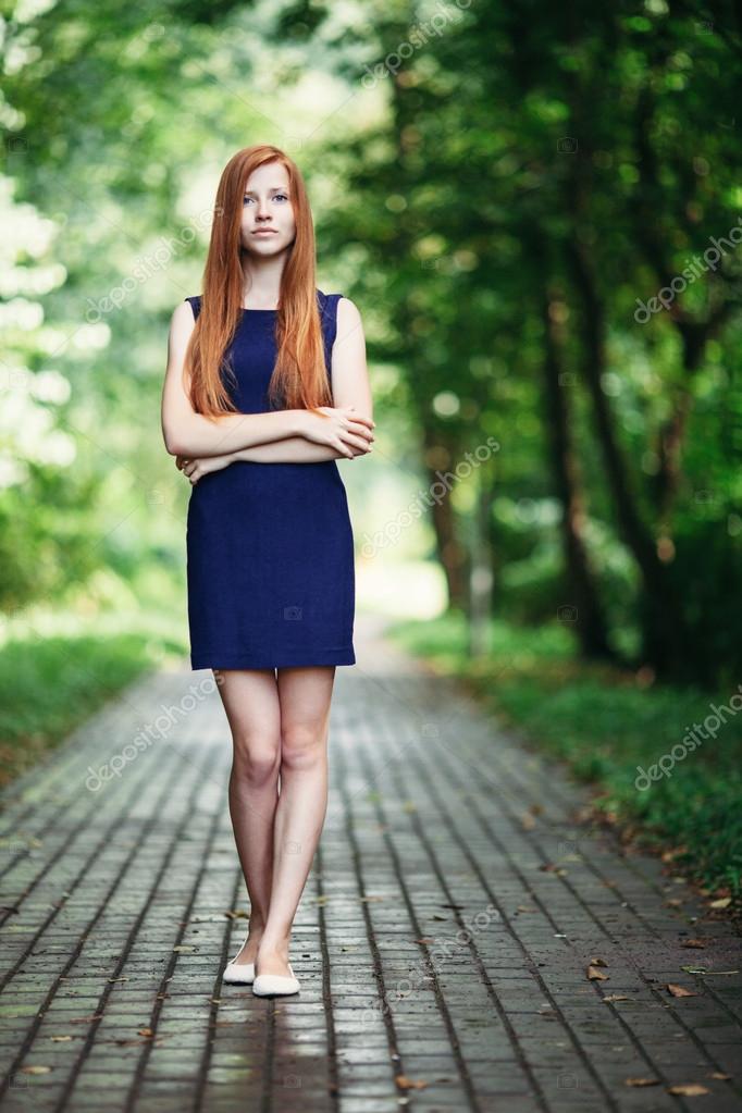 Romantic Cute Redhead Lady In A Blue Dress With A Forest Park