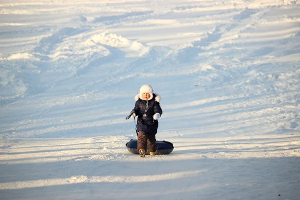 Girl rides snow tubing