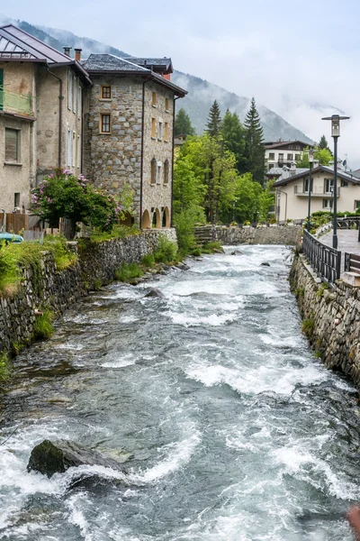 Water flows in a creek between stones in Ponte di Legno, Italy