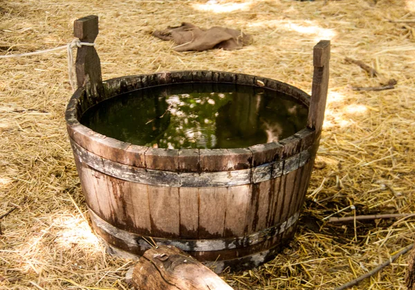 Antique bucket with water in the courtyard of a castle