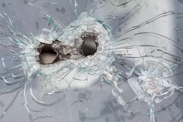 Rifle bullets holes on a car glass