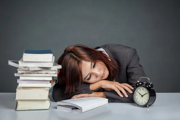 Asian businesswoman get tired reading many books