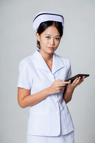 Young Asian nurse with a tablet pc