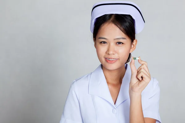 Asian young nurse show a capsule