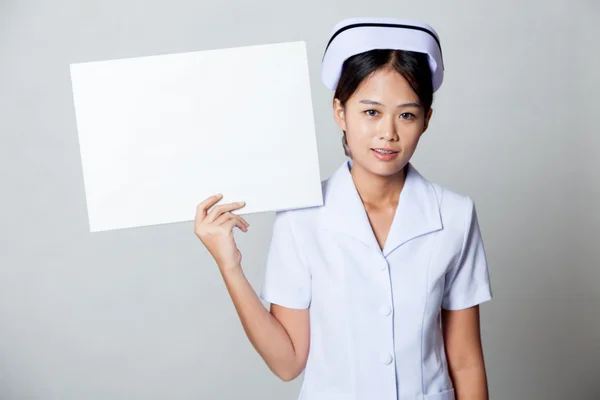 Young Asian nurse show blank sign on her shoulder