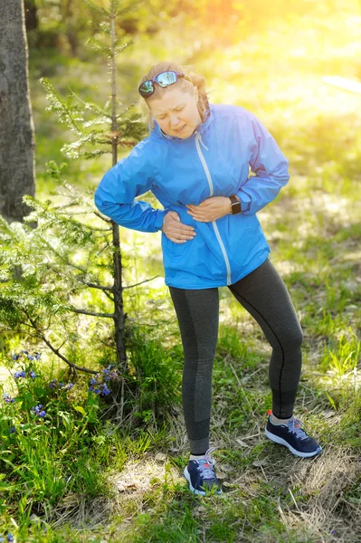Side stitch - woman runner side cramps.